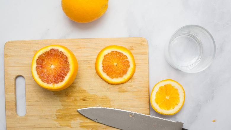 sliced oranges on wooden board
