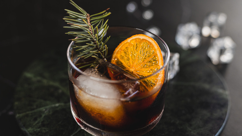 cocktail with pine and orange slice