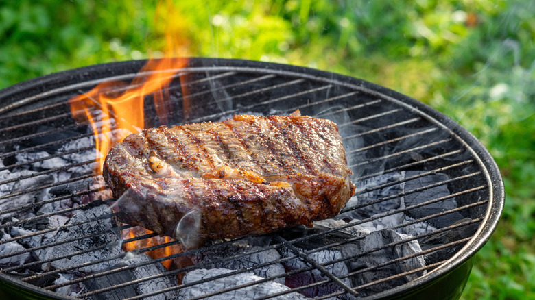 steak on charcoal grill
