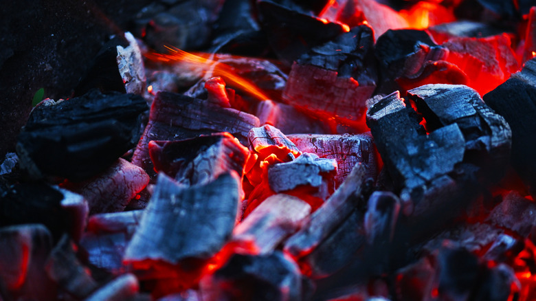 Burning wood charcoal with glowing red embers