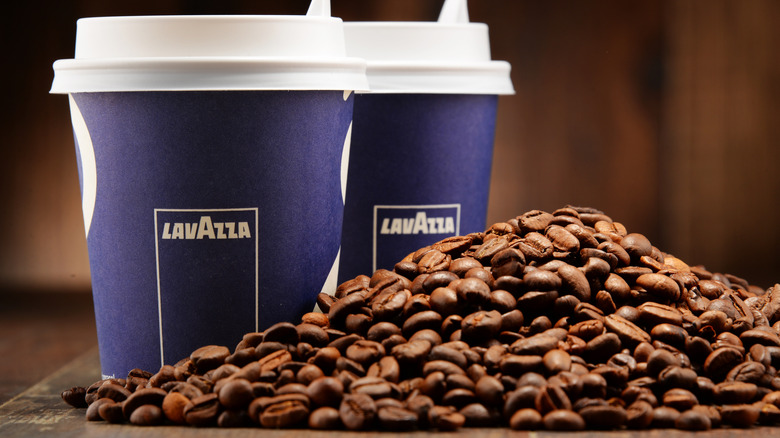 Whole bean coffee with two Lavazza cups