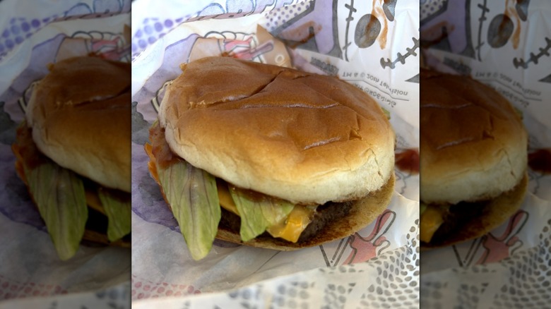 Jack in the Box Krusty Burger of Terror cheeseburger sitting on paper wrapping