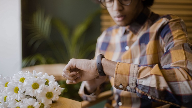 Man at a restaurant checking his watch