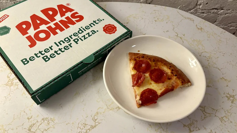 Slice of pepperoni pizza with Papa Johns box