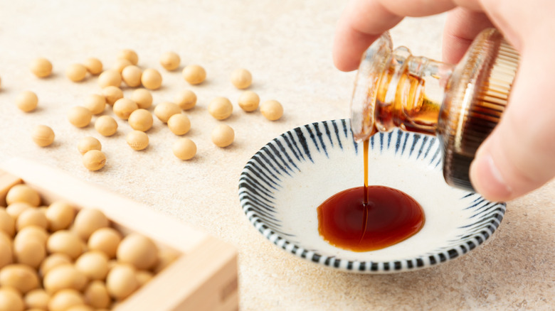 Soy sauce getting poured into a bowl