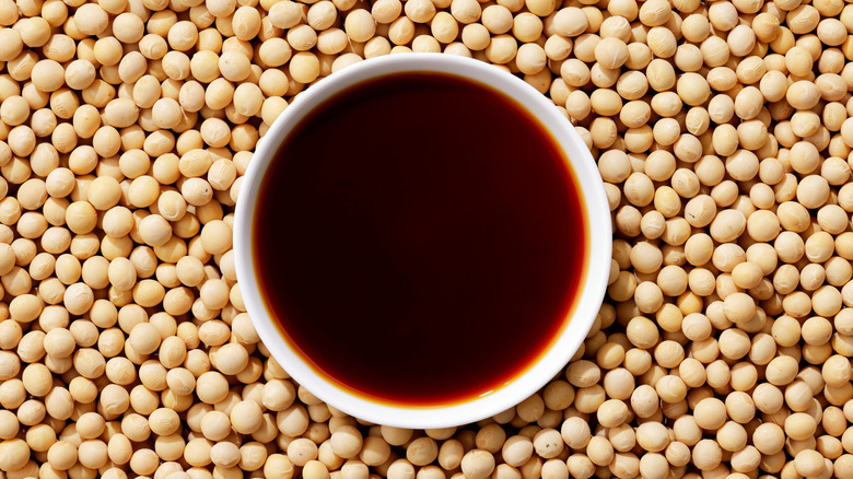 Soy sauce surrounded by soybeans