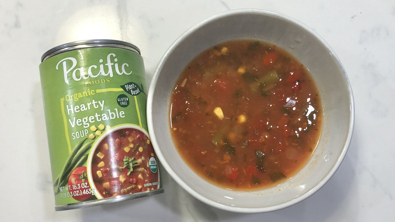 can of Pacific Foods hearty vegetable soup and a bowl of soup
