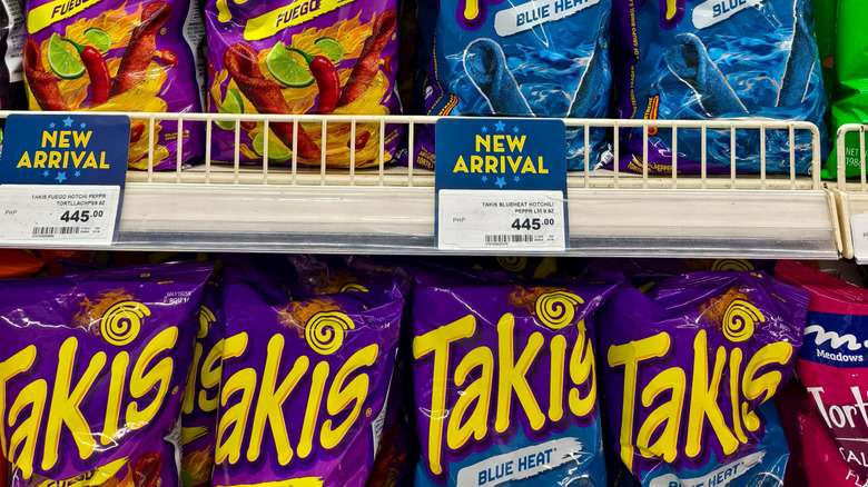 Different bags of Takis flavors on shelves