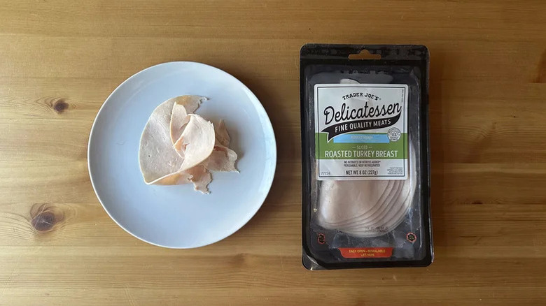 TJs reduced sodium deli meat turkey on a plate over wood