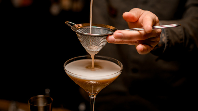bartender straining espresso martini