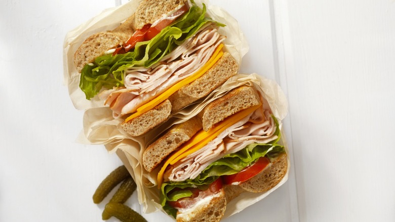 Sandwich halves wrapped in paper