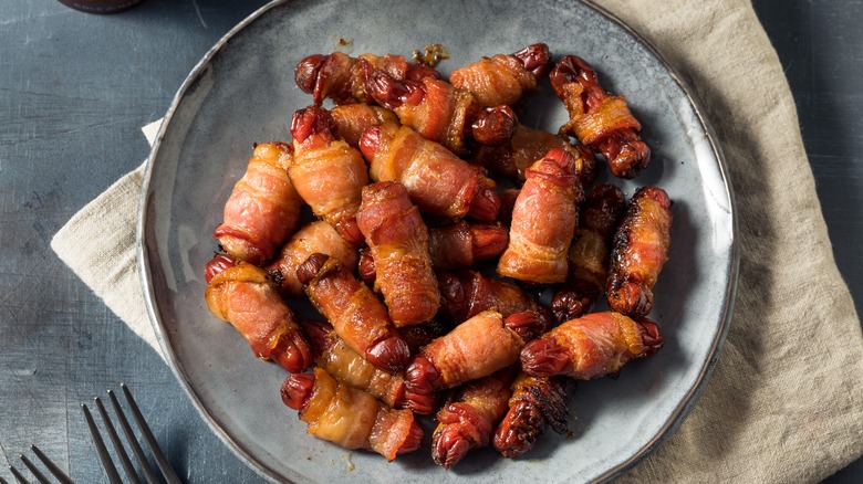 Plate of bacon-wrapped cocktail sausages 