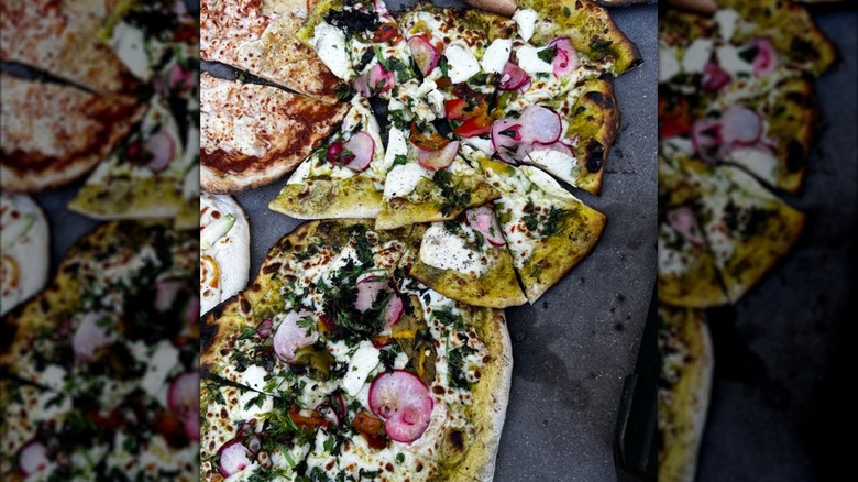 Assortment of pizzas with vegetable and cheese toppings