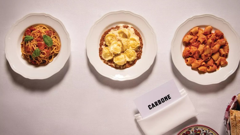Three pasta dishes on white table