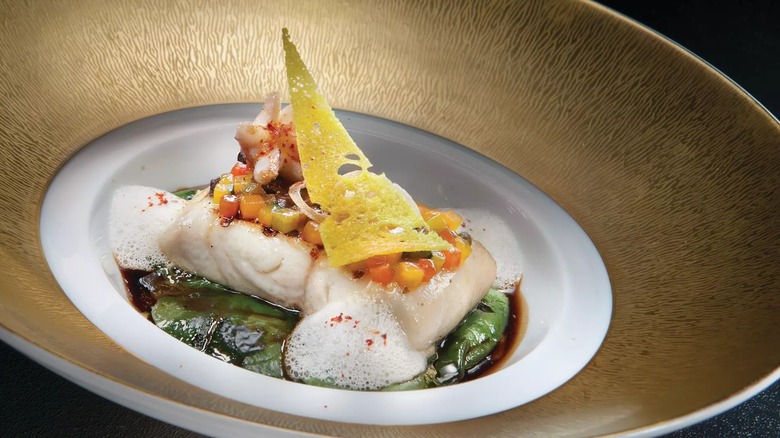 Fancy fish dish with foam in gold plate
