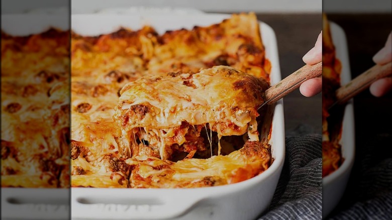 Taking a slice of lasagna out of a baking dish