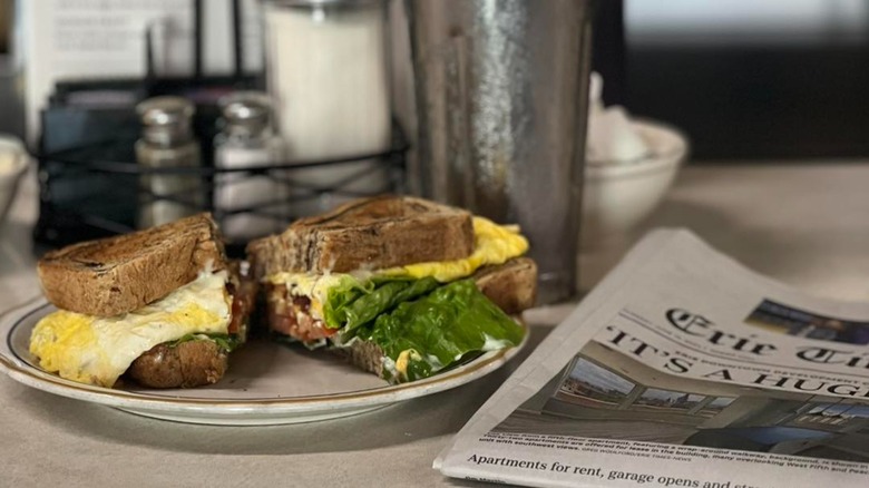 Egg sandwich on a diner counter with a newspaper