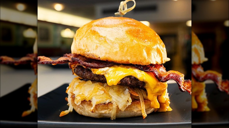 Breakfast burger with bacon, cheese, and hash browns