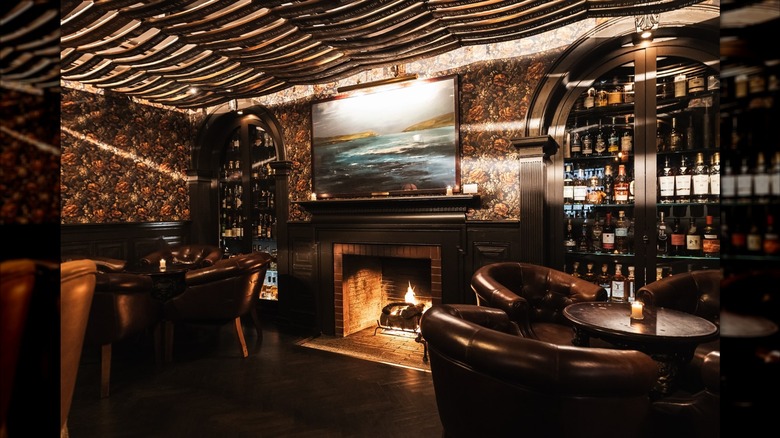 Fireplace, tables, and cabinets of whiskey at Fraunces Tavern