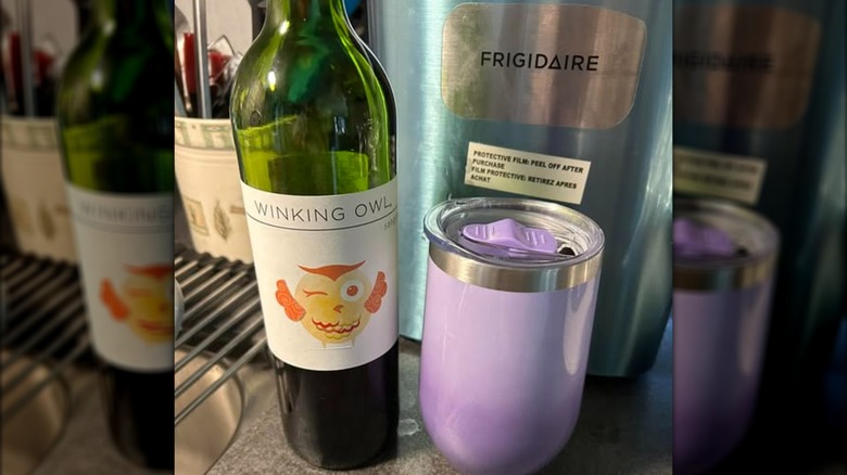 Bottle of Winking Owl wine with a travel cup