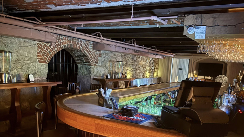 An underground bar with stone brick walls