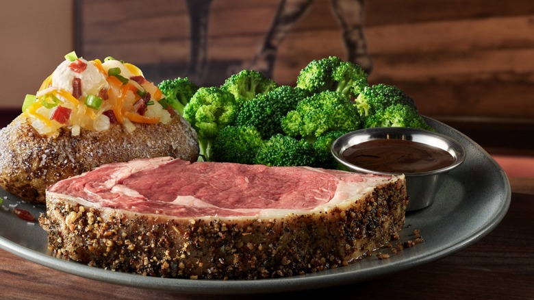 Prime rib with bakes potato, broccoli, and cup of au jus