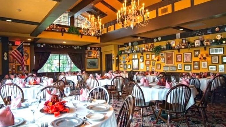 Gulliver's dining room with round tables, wooden chairs, and yellow-orange walls