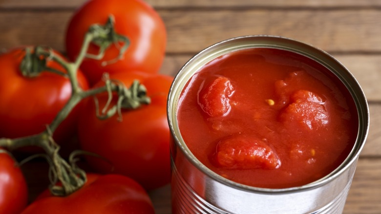 Canned tomatoes with fresh tomatoes on side