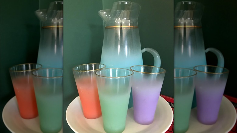 Blendo set of purple, green, and red glasses with a blue pitcher