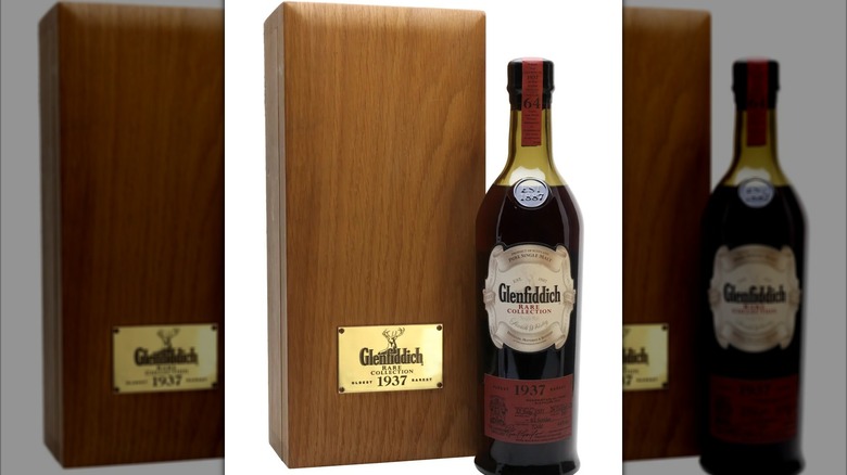 Bottle of Glenfiddich 1937 with its wooden presentation box on a white background