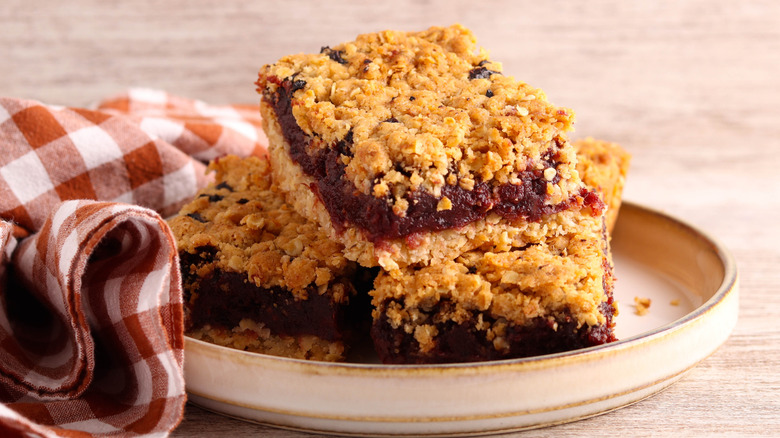 plate of stacked oat bar cookies with apple and date filling