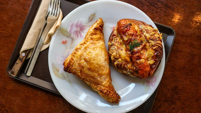 overhead of turnover and Danish pastry on white plate