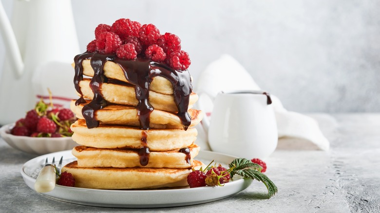 Stack of pancakes with raspberries