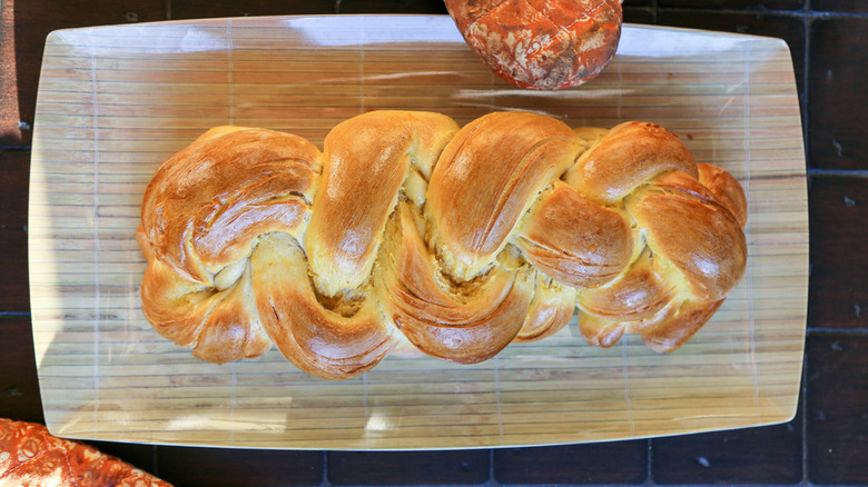 Top-down view of a challah loaf on a serving platter