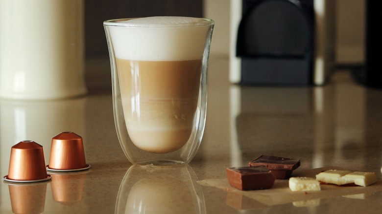 Nespresso espresso shot with pods and chocolate pieces