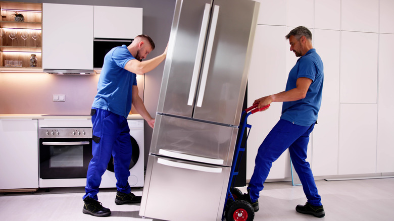 two men moving a refrigerator