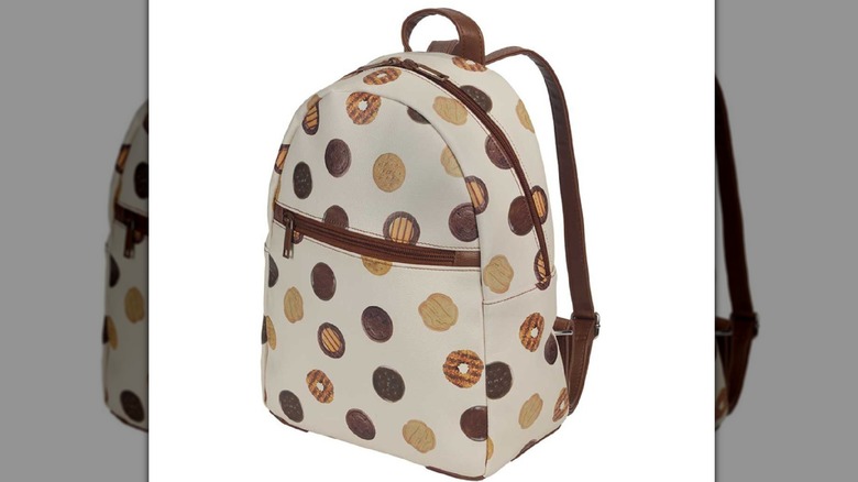 White backpack with brown straps and Girl Scout Cookie themed pattern