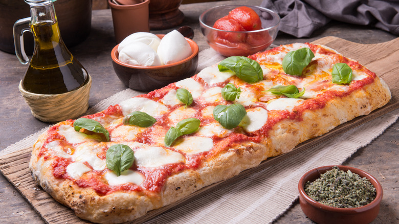 Homemade focaccia pizza with tomato, basil, and oregano