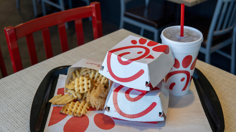 Chick-Fil-A meal with fries, food boxes, and drink