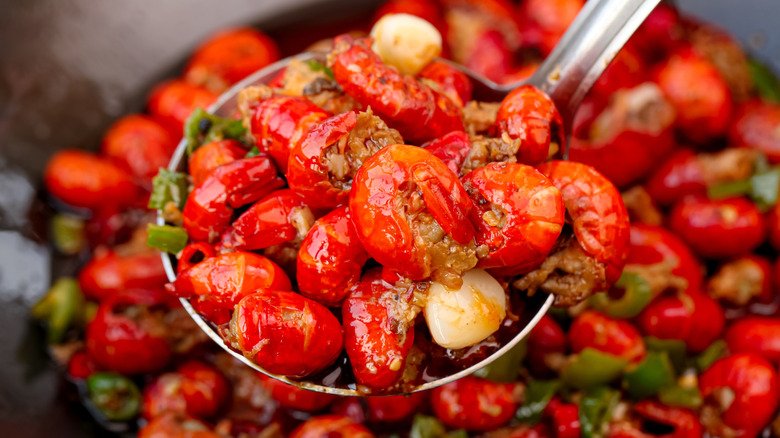 Red crawfish on metal ladle.