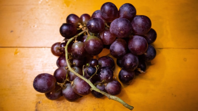A bunch of red grapes on the stem