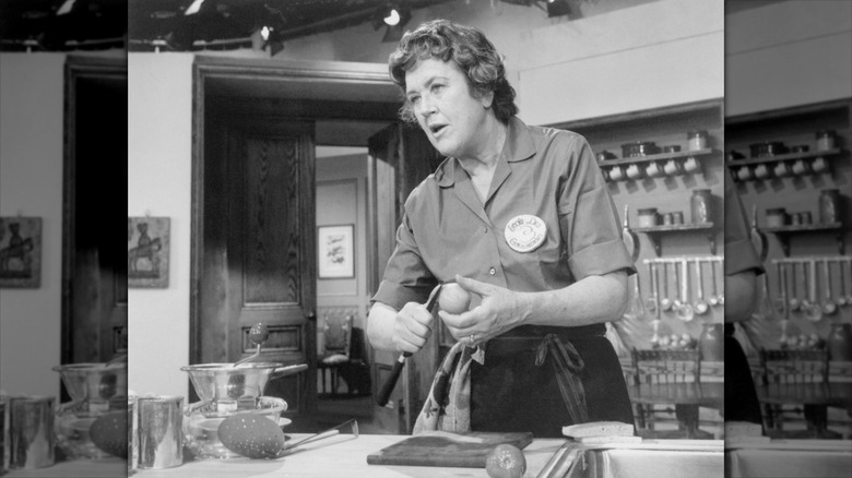 Julia Child cooking at her kitchen island