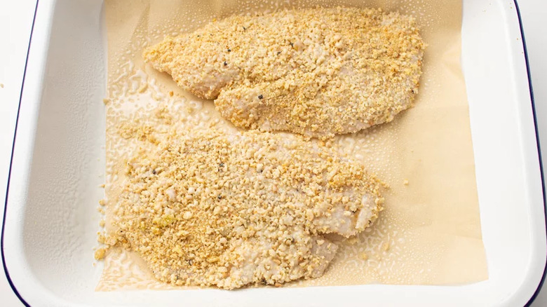 Tilapia filets with oil in dish