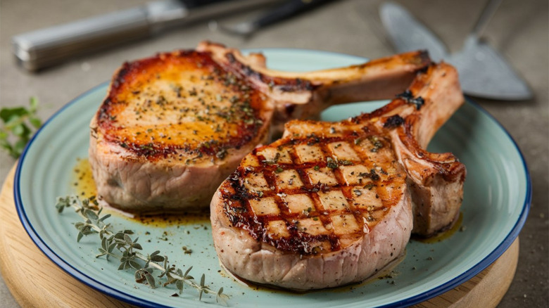 Grilled pork chops on a blue plate