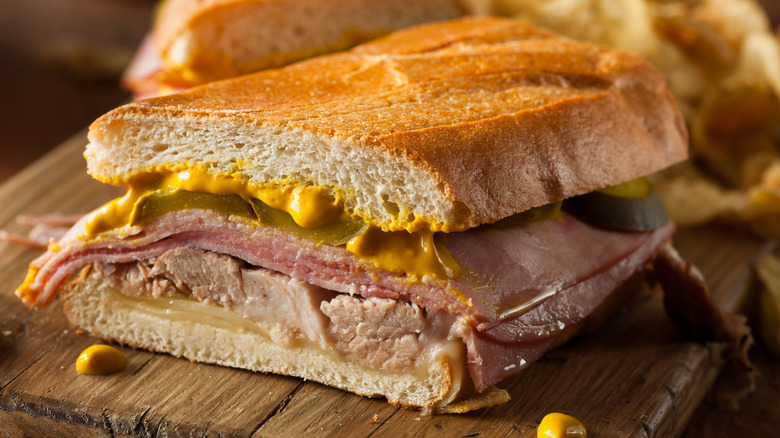 Cuban sandwich stacked with pork, mustard, and cheese
