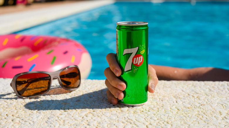 can of 7UP soda near pool with float