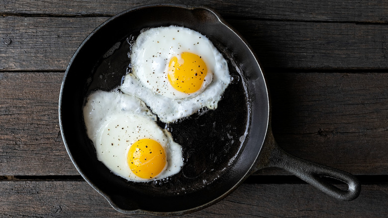 Fried eggs with pepper in a cast iron pan