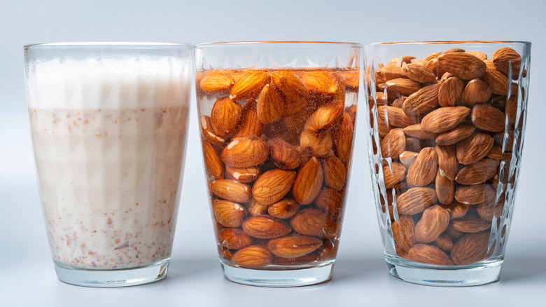 glasses of dry almonds, soaked almonds, and almond milk