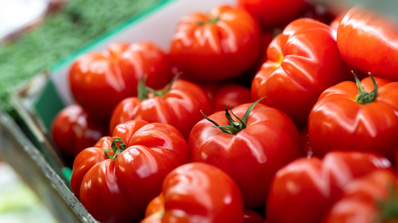 A crate of ripe tomatoes