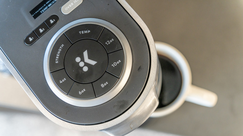 top view of a Keurig machine with a cup of coffee being brewed